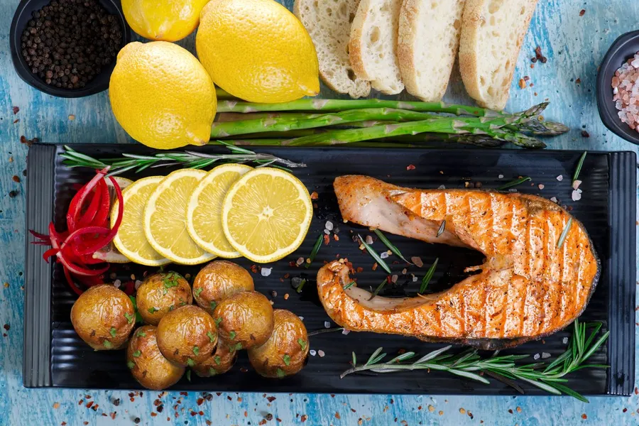 Salmon with asparagus, potatoes, and lemon on a plate